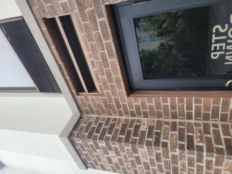 Exterior brick wall beside a door